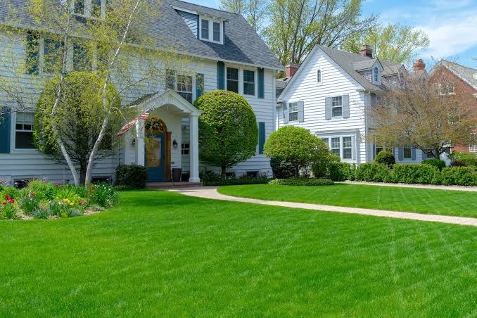 White colonial home with a grey roof